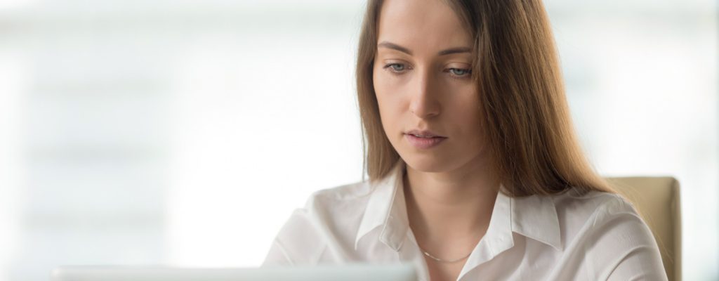 Mulher jovem, com síndrome da visão de computador, trabalhando em seu escritório.